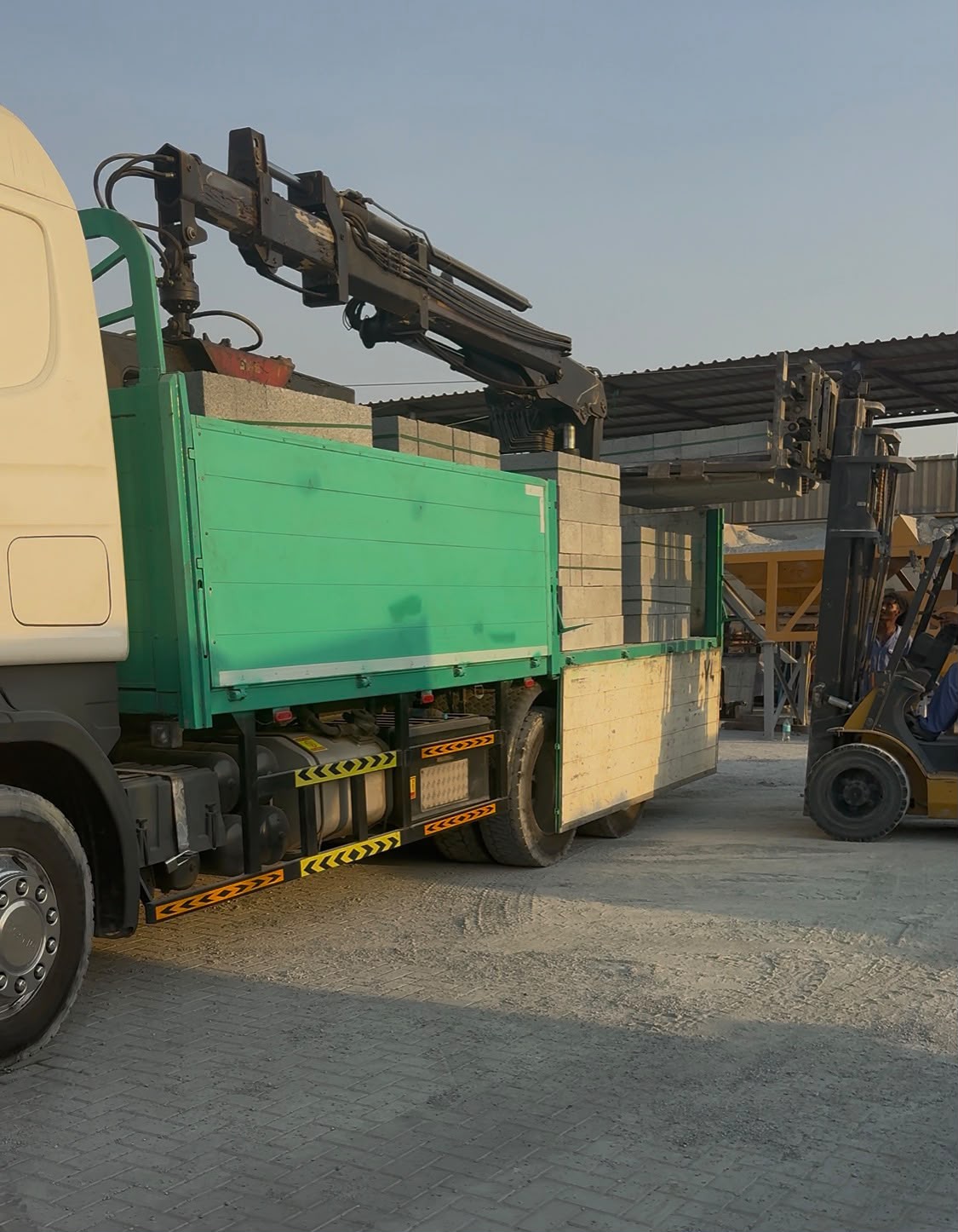Concrete blocks being loaded onto a delivery truck